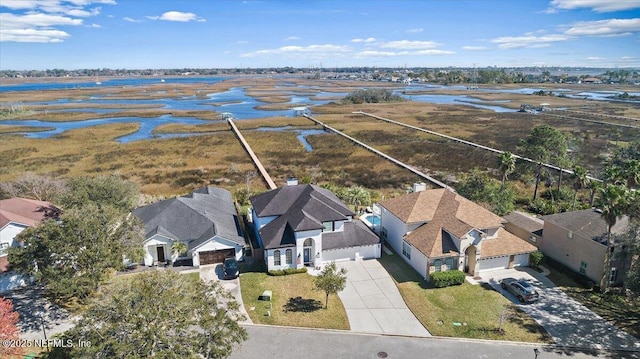 drone / aerial view featuring a water view and a residential view