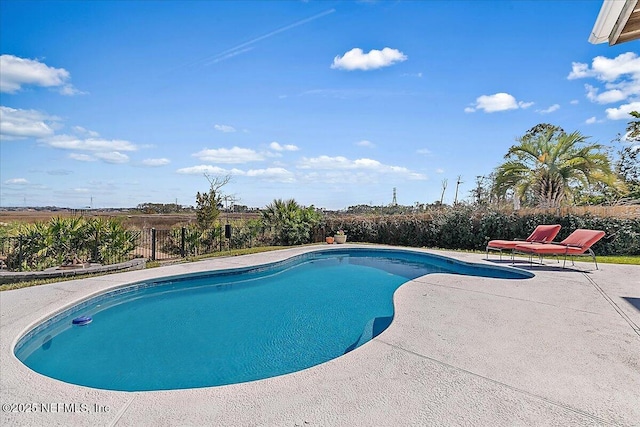 view of swimming pool with a patio area, fence, and a fenced in pool