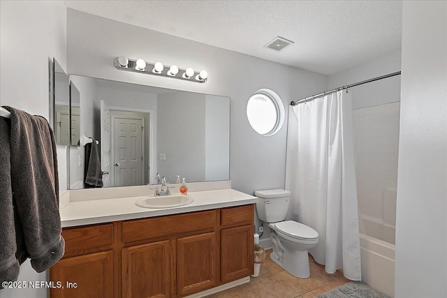 full bathroom with visible vents, toilet, vanity, a textured ceiling, and tile patterned floors