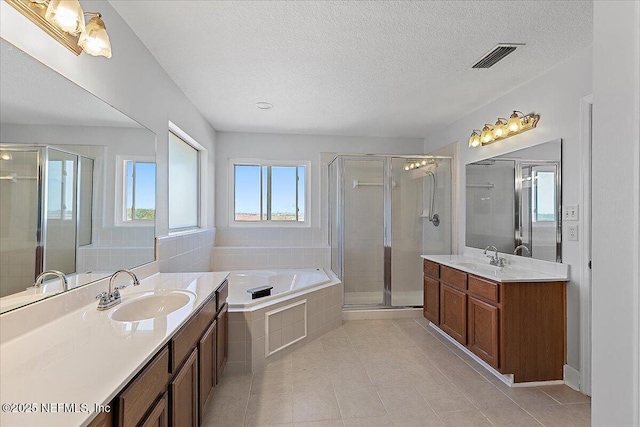 full bathroom with a stall shower, visible vents, and a sink