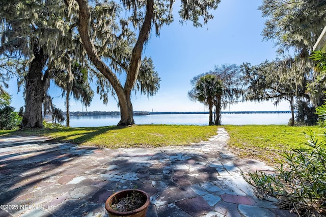 view of patio with a water view