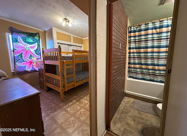 bedroom featuring a textured ceiling and tile patterned floors