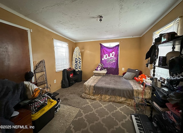 bedroom with carpet floors, ornamental molding, and baseboards