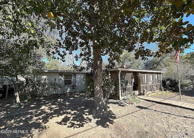 back of house featuring a chimney