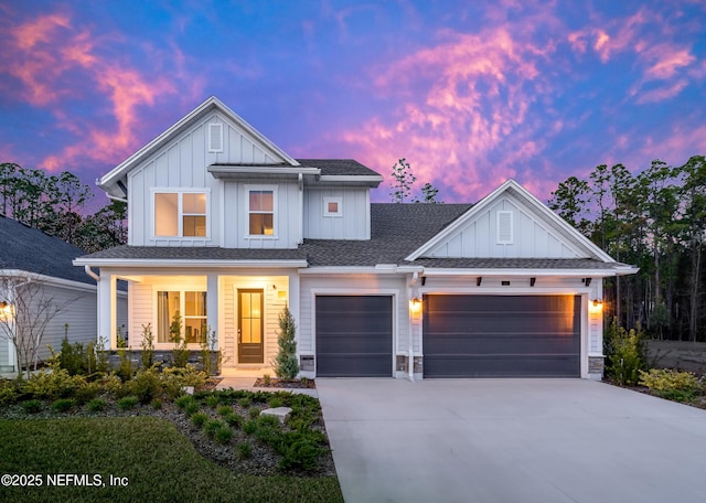 modern inspired farmhouse featuring a porch, a garage, a shingled roof, driveway, and board and batten siding