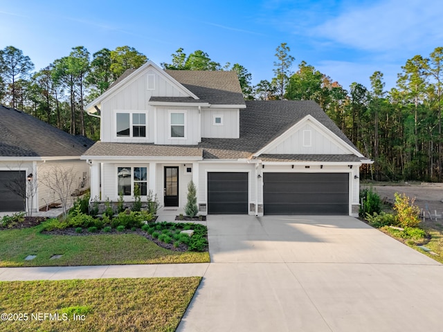 modern inspired farmhouse featuring a garage, a shingled roof, concrete driveway, board and batten siding, and a front yard