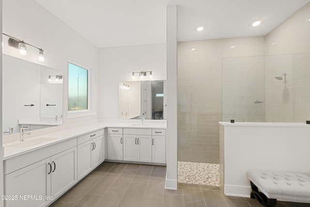 full bath with tile patterned flooring, vanity, recessed lighting, and walk in shower