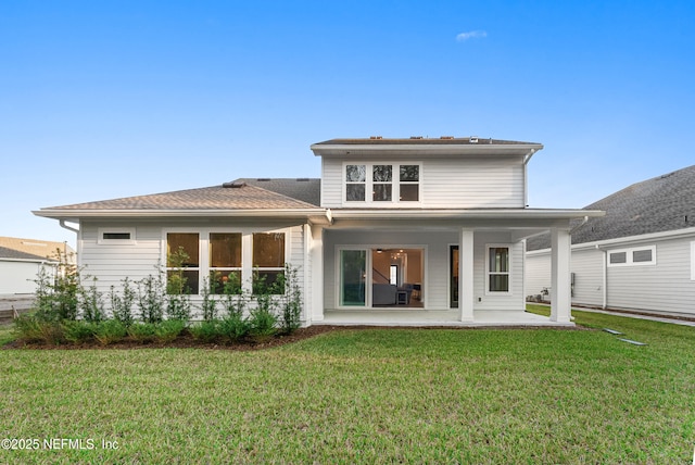 back of property featuring a patio area and a yard