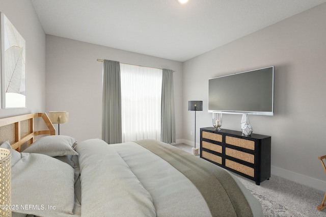 bedroom with carpet and baseboards