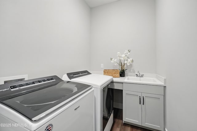 152 Navigators Rd, Saint Johns, FL 32259 - washroom featuring separate washer and dryer, a sink, cabinet space, and dark wood finished floors