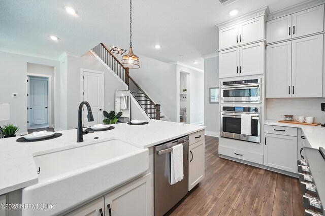 152 Navigators Rd, Saint Johns, FL 32259 - kitchen with a sink, dark wood finished floors, pendant lighting, crown molding, and appliances with stainless steel finishes