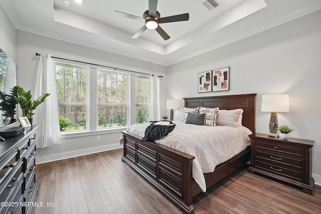 152 Navigators Rd, Saint Johns, FL 32259 - bedroom with ceiling fan, a tray ceiling, baseboards, dark wood-type flooring, and visible vents