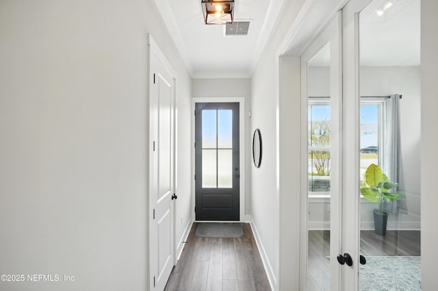 152 Navigators Rd, Saint Johns, FL 32259 - doorway to outside with baseboards, visible vents, dark wood-type flooring, and crown molding
