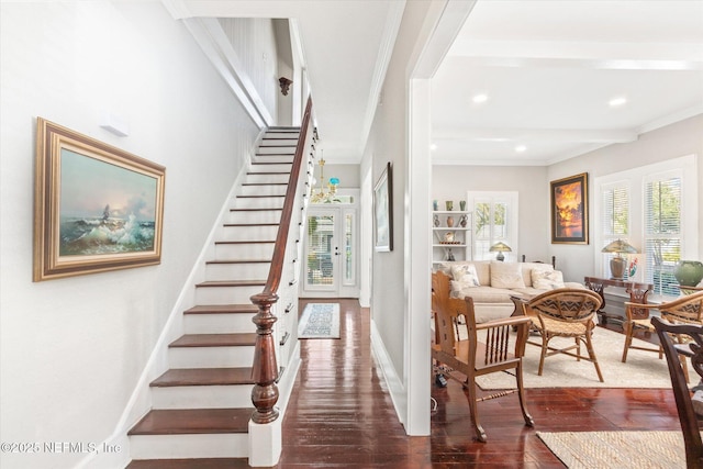 stairway with baseboards, ornamental molding, wood finished floors, and beamed ceiling