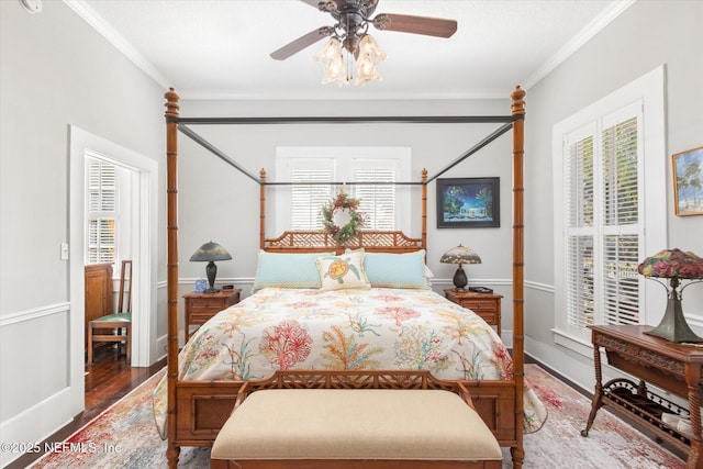 bedroom featuring ceiling fan, ornamental molding, wood finished floors, and baseboards