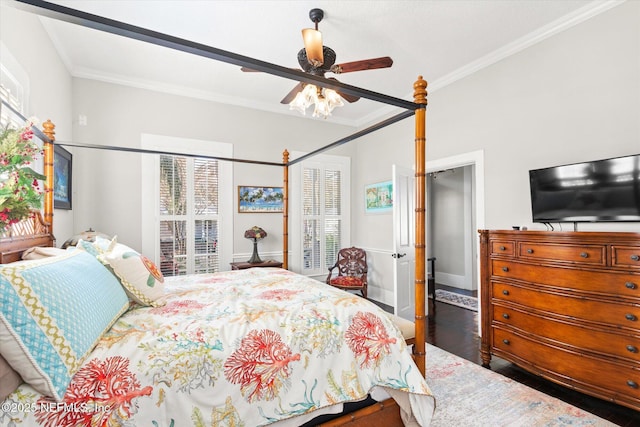 bedroom with ornamental molding, dark wood finished floors, and a ceiling fan