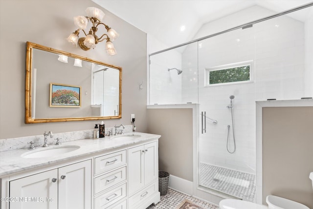 full bathroom featuring double vanity, a shower stall, vaulted ceiling, and a sink