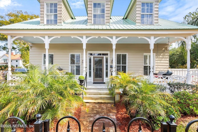 exterior space featuring metal roof and a porch