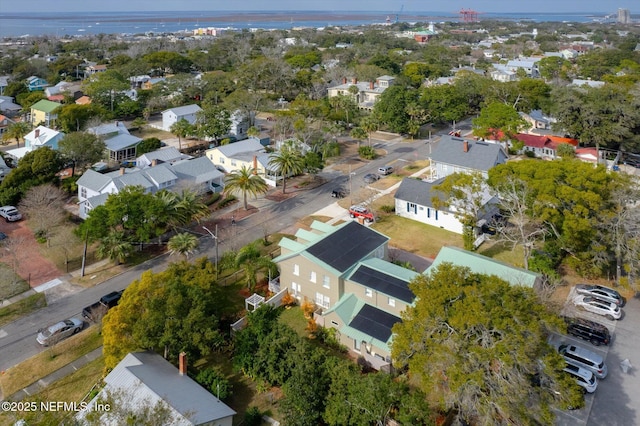 drone / aerial view with a residential view and a water view