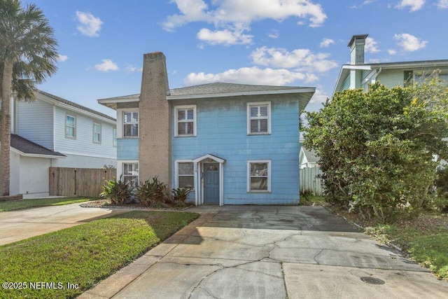 view of front of property featuring a chimney and fence