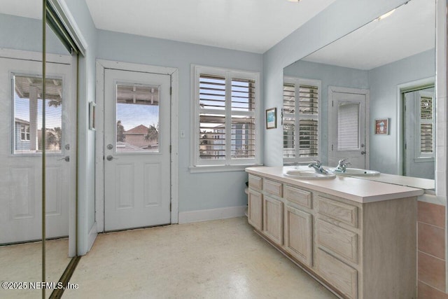 bathroom with baseboards and vanity