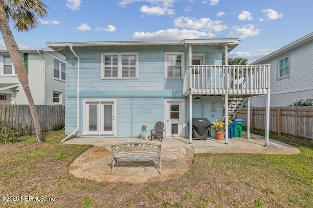 rear view of house with a patio area, a yard, and a fenced backyard