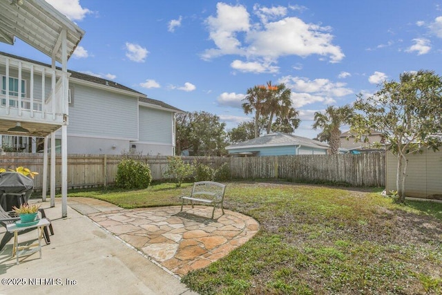 view of yard with a patio area and a fenced backyard