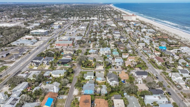 aerial view with a water view, a residential view, and a view of the beach