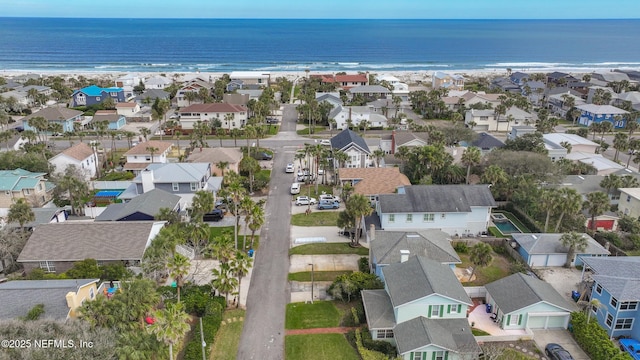 bird's eye view featuring a beach view, a water view, and a residential view