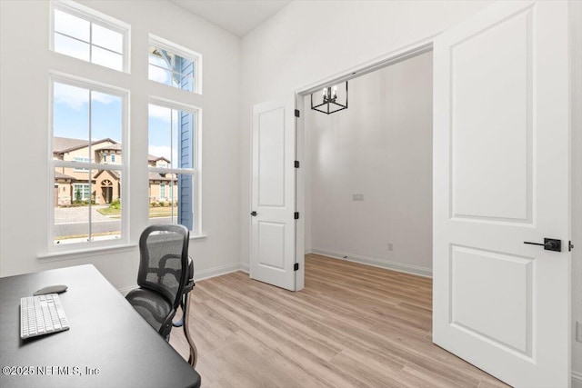 office space with light wood-style floors and baseboards