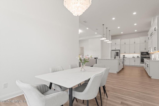 dining area featuring a chandelier, recessed lighting, visible vents, baseboards, and light wood-style floors