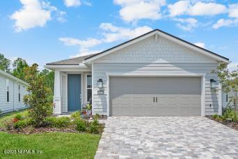 view of front of house featuring decorative driveway and an attached garage