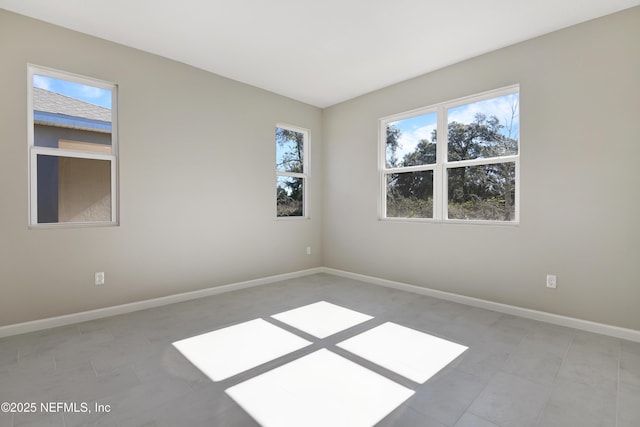 spare room featuring baseboards