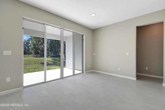 unfurnished room featuring baseboards