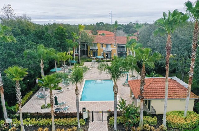 pool with fence and a patio