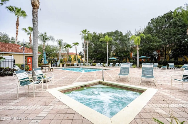 pool featuring a patio and a hot tub