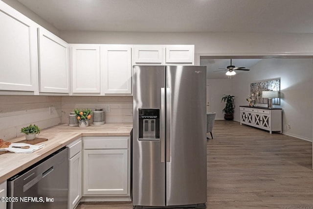 kitchen with dark wood-type flooring, wood counters, white cabinetry, a ceiling fan, and appliances with stainless steel finishes