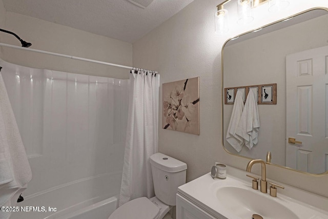 full bath with shower / tub combo, a textured ceiling, toilet, and vanity