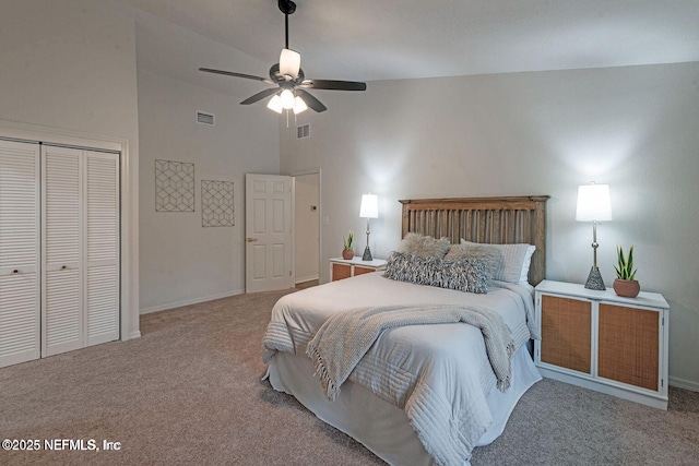 bedroom with high vaulted ceiling, carpet, visible vents, and a closet