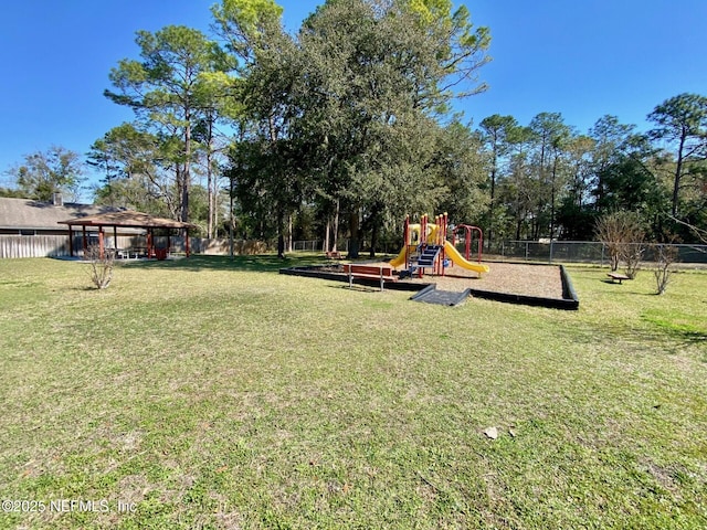 community jungle gym with a yard, a gazebo, and fence