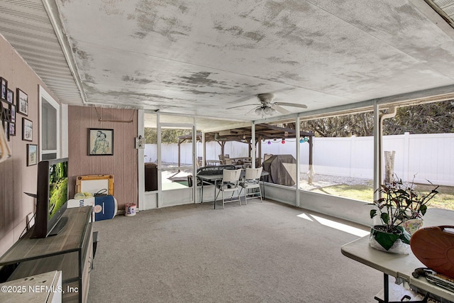 sunroom / solarium with a ceiling fan