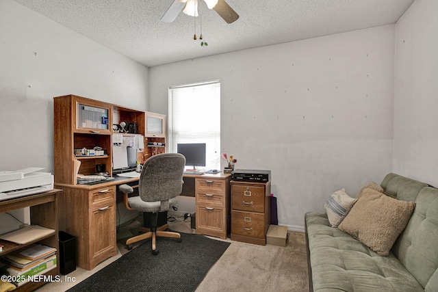 office space featuring light carpet, a textured ceiling, and a ceiling fan