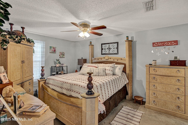 bedroom with a textured ceiling, ceiling fan, light carpet, and visible vents