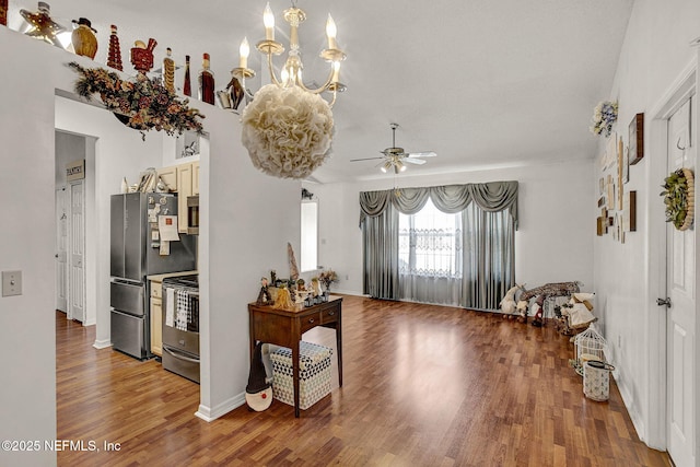 entryway with wood finished floors and ceiling fan with notable chandelier