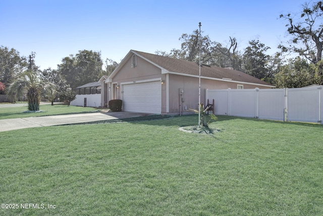 view of property exterior featuring a yard, concrete driveway, and fence