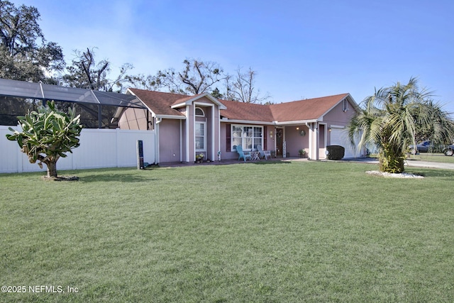 single story home with a garage, a front lawn, fence, and stucco siding