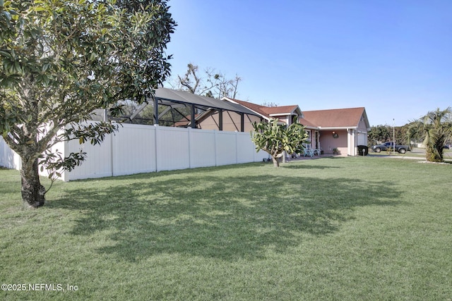 view of yard featuring a garage and fence