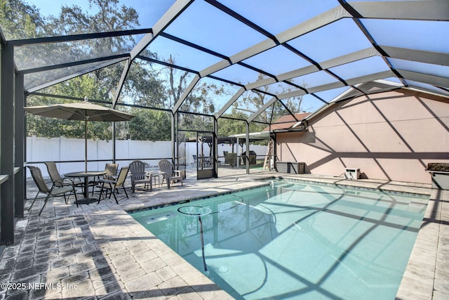 view of pool featuring a lanai, fence, a fenced in pool, and a patio