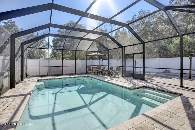 view of pool with a patio, a fenced backyard, a fenced in pool, and a lanai