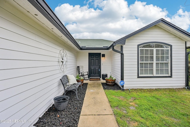 property entrance with a yard